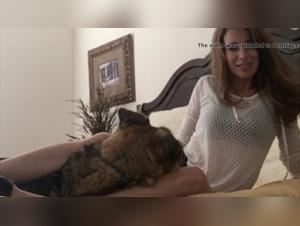 A mature woman engages in a doggy style with her own dog