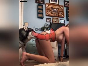 The young woman holds her dog in her arms to engage in a hard fuck